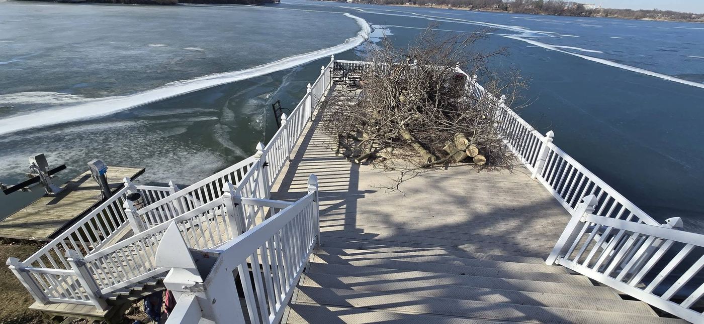 Old white railing dock with storm debris before renovation
