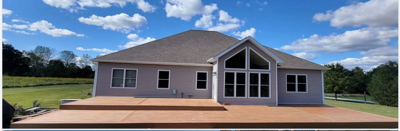 Large rear composite deck on a house with gable roof