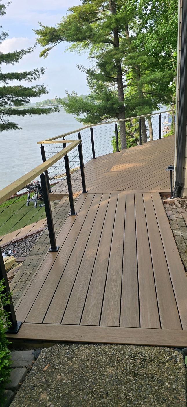 Long composite deck with cable railing winding along the lakeshore