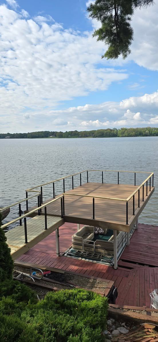 Elevated dock structure with railing over the water