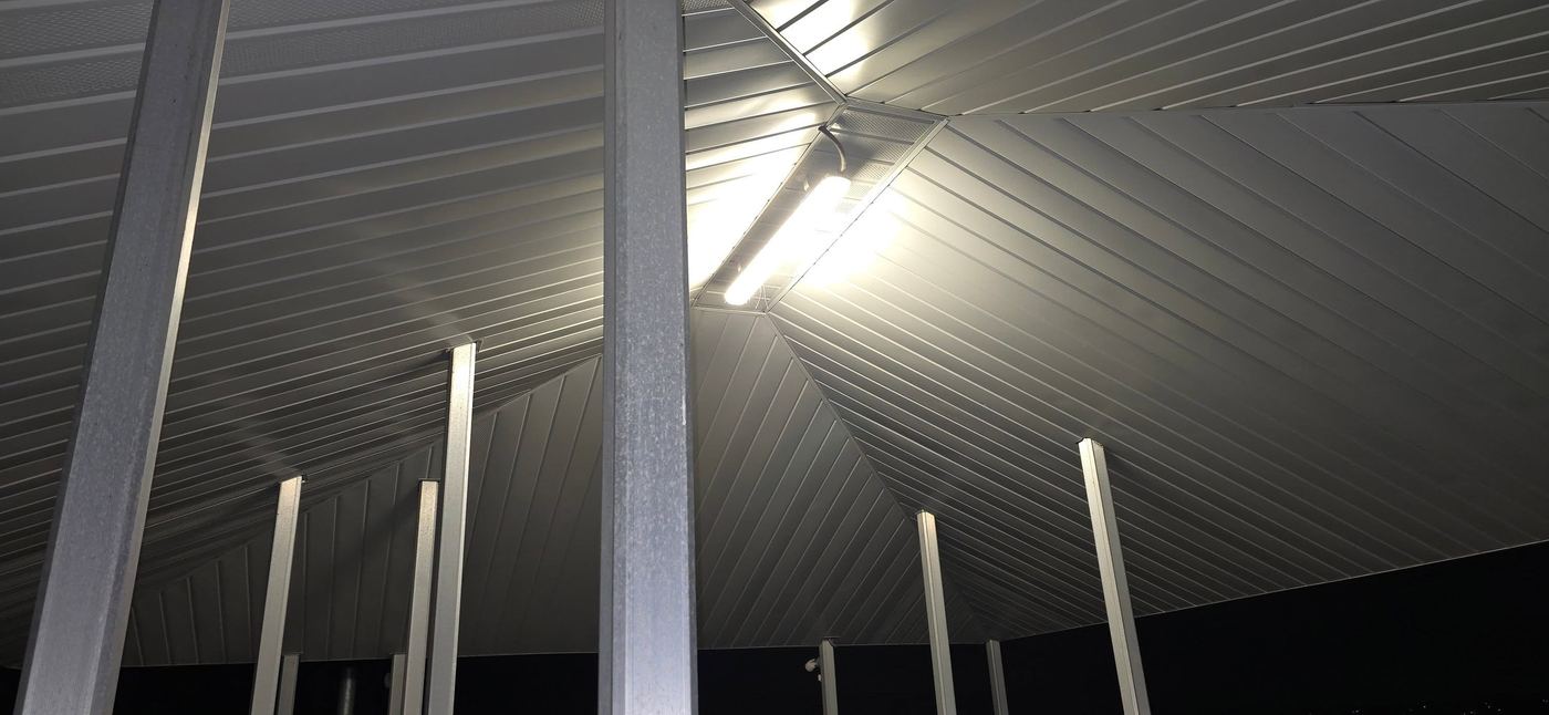 Hip roof ceiling structure over a floating dock with lighting